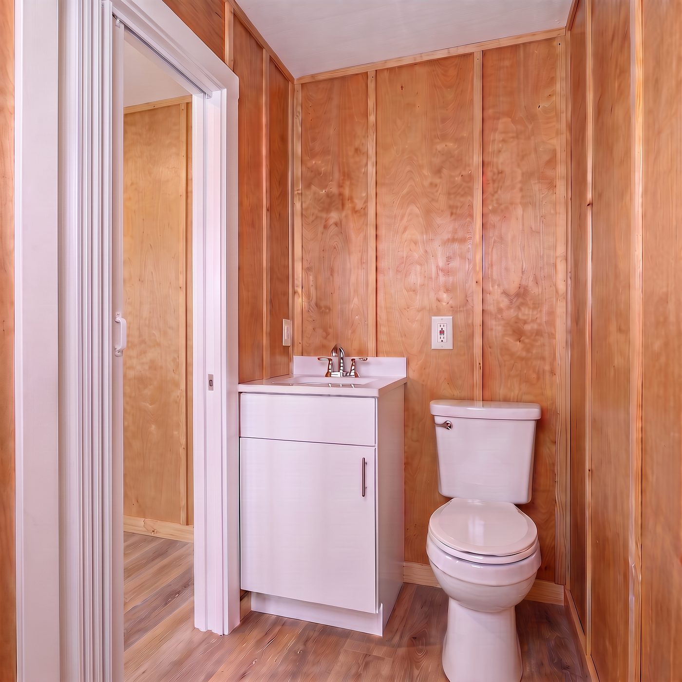 Sport 160 bath with a white vanity, toilet and accordion door