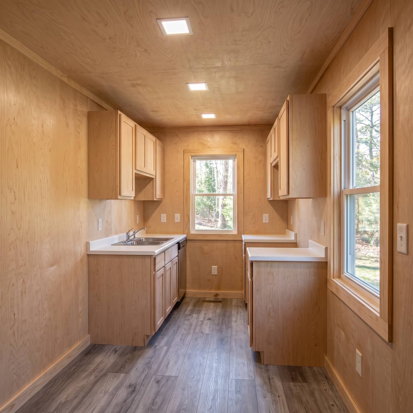 Sport 320 galley kitchen with unfinished maple cabinets and sanded plywood walls